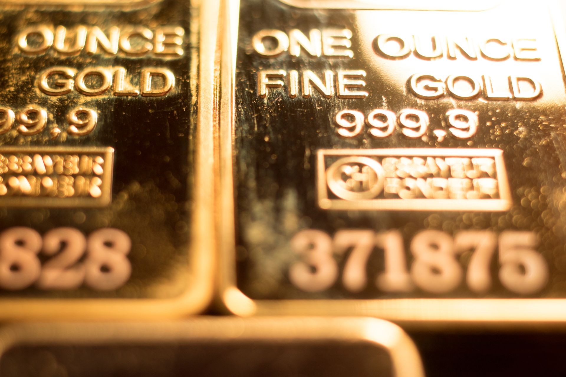 Fine solid gold 999.9 one ounce bullion ingot precious metals bar closeup isolated photo.